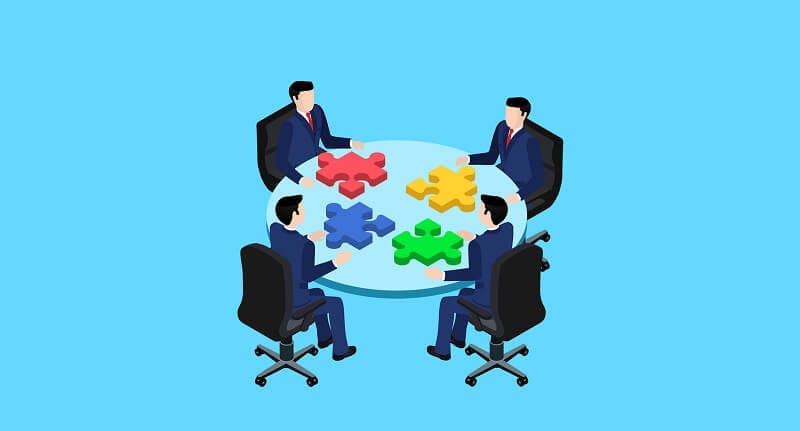 oportunidades quatro executivos sentados a mesa montando quebra cabeça com suas respectivas peças