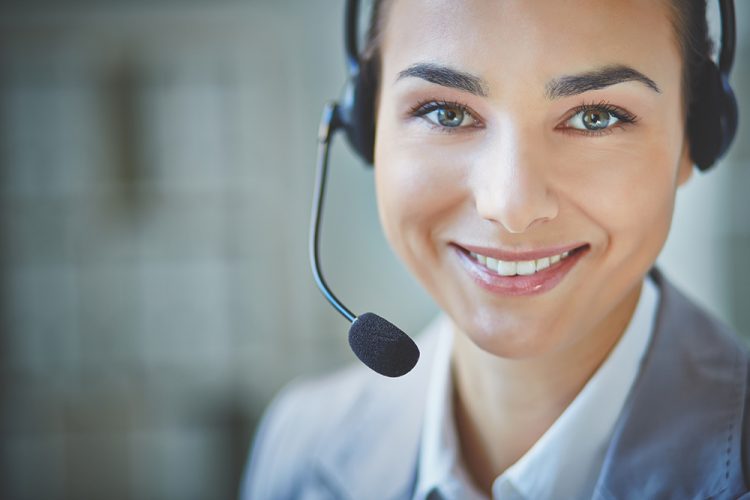 Young customer support representative looking at camera with smile
